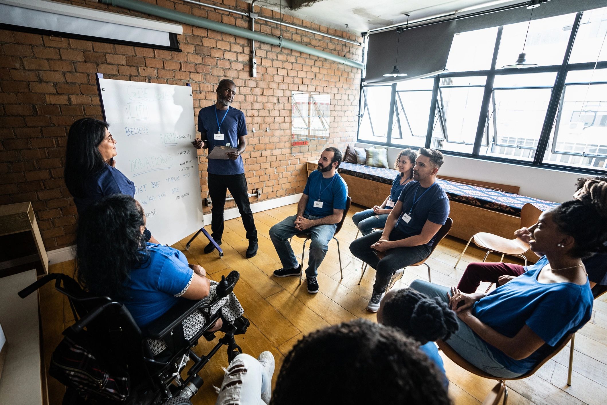Facilitator speaking with community members during a workshop