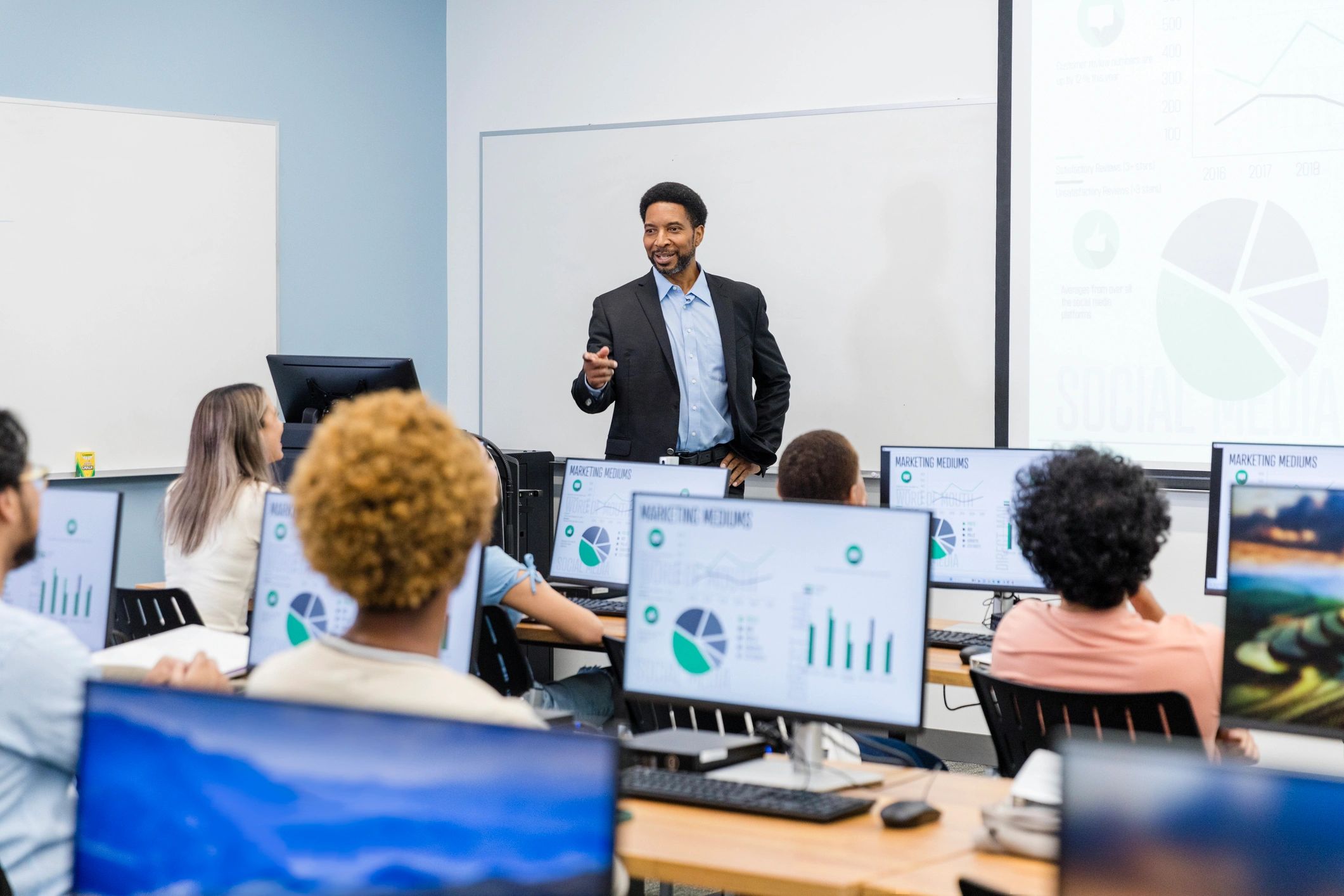 Facilitator teaching a class at a whiteboard