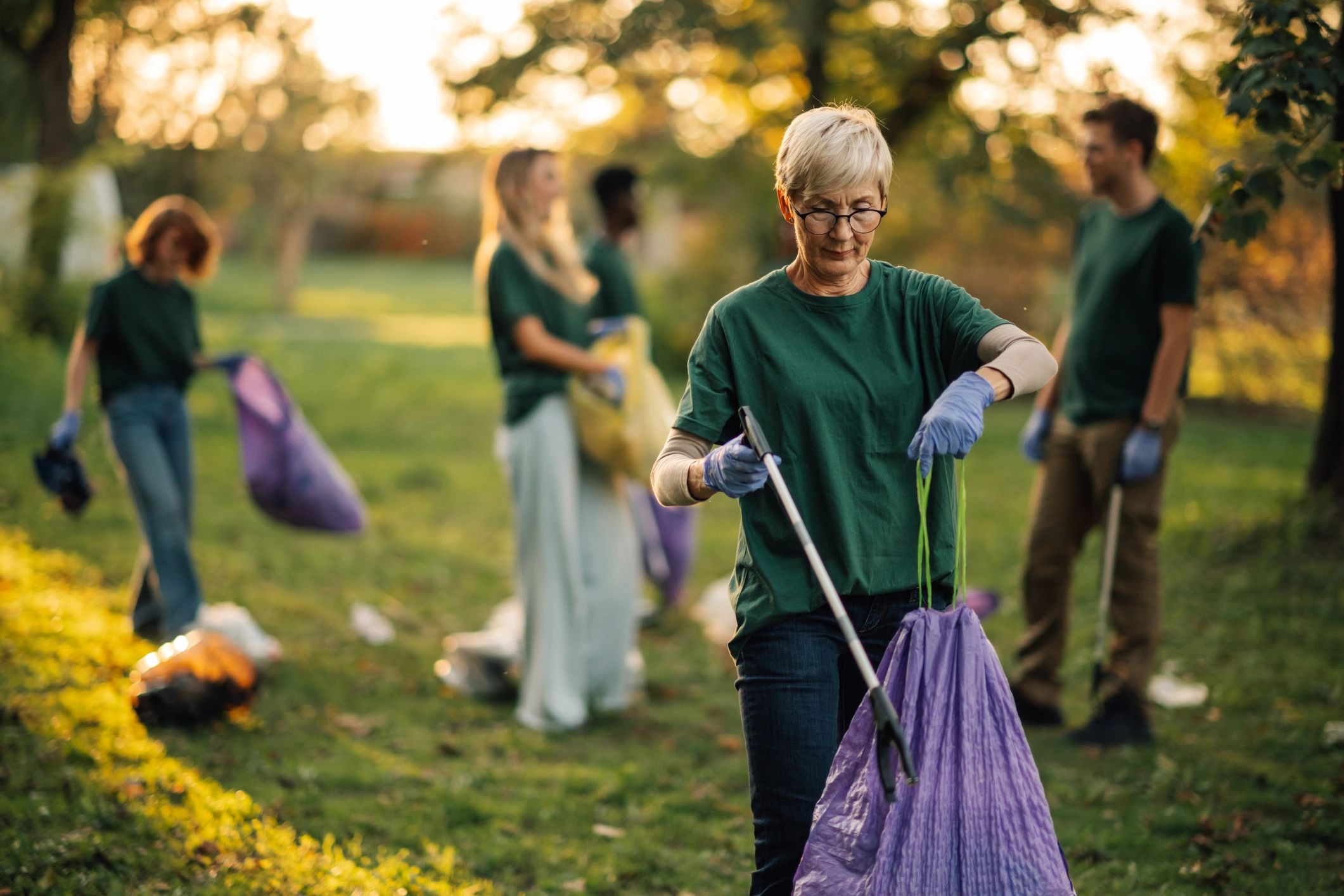 Volunteers cleaning up a park during a service day